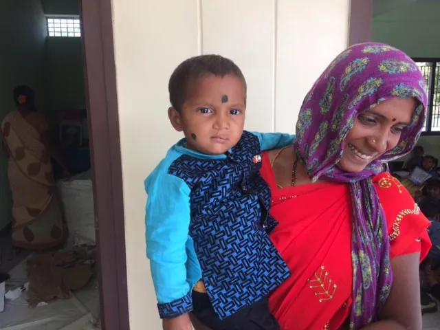 A mother holding her young son at St. John's