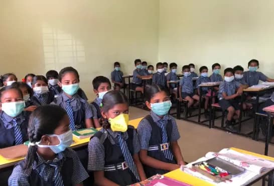 Students back in the classroom wearing masks
