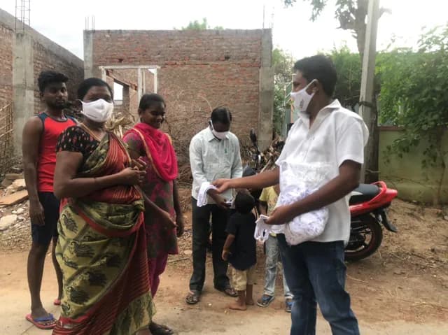 Staff distributing masks to families in the village