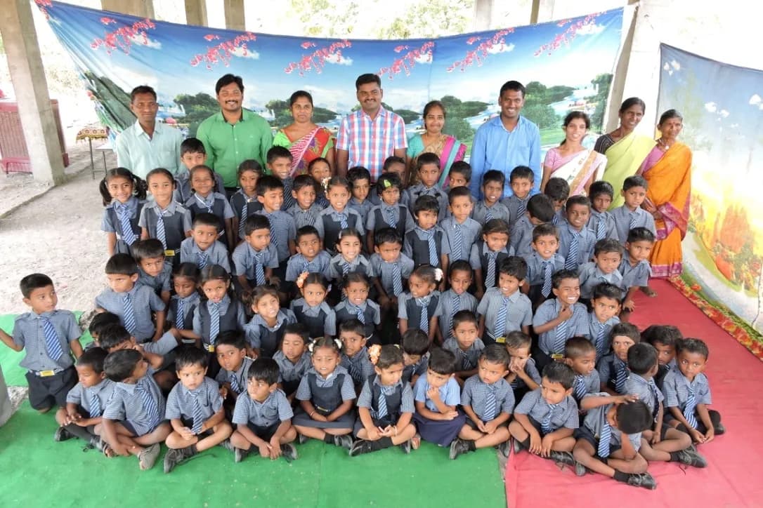 The full preK–1st class of 76 students, with staff and visiting team