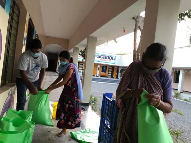 Staff handing out bags of rice to families