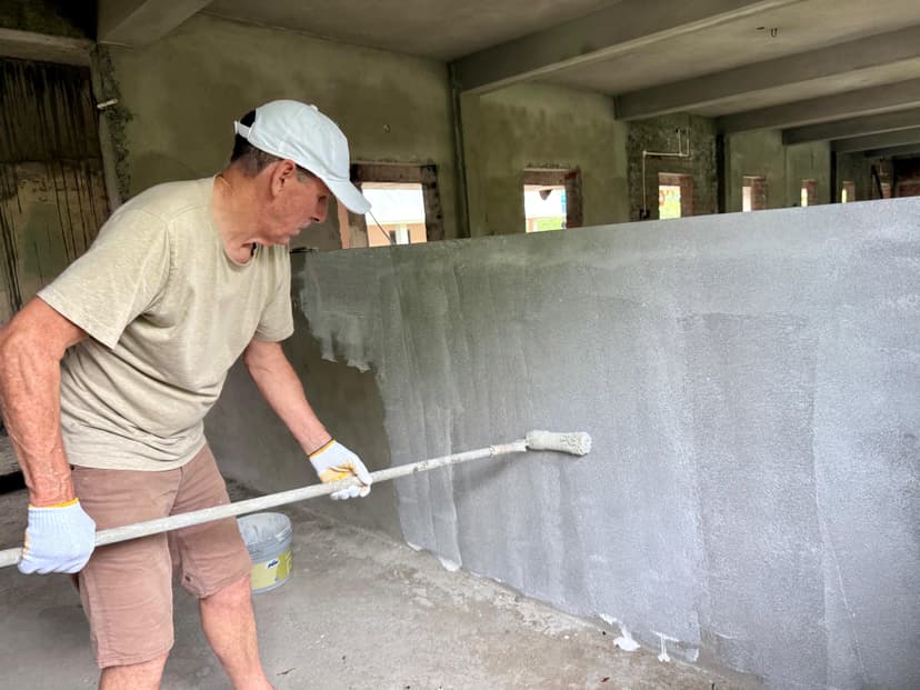 Ray Stark painting a classroom wall at St. John's