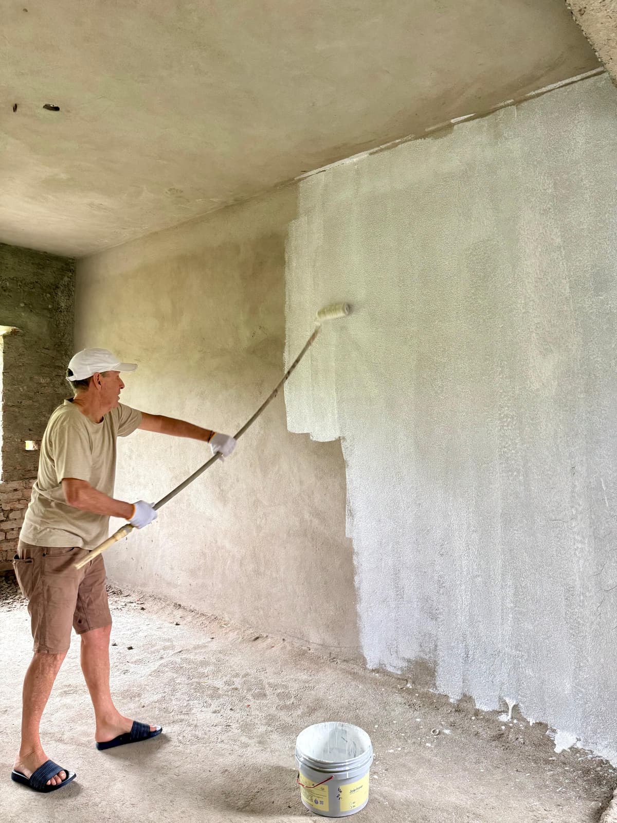 Mr. Ray Stark painting a classroom wall at St. John's School